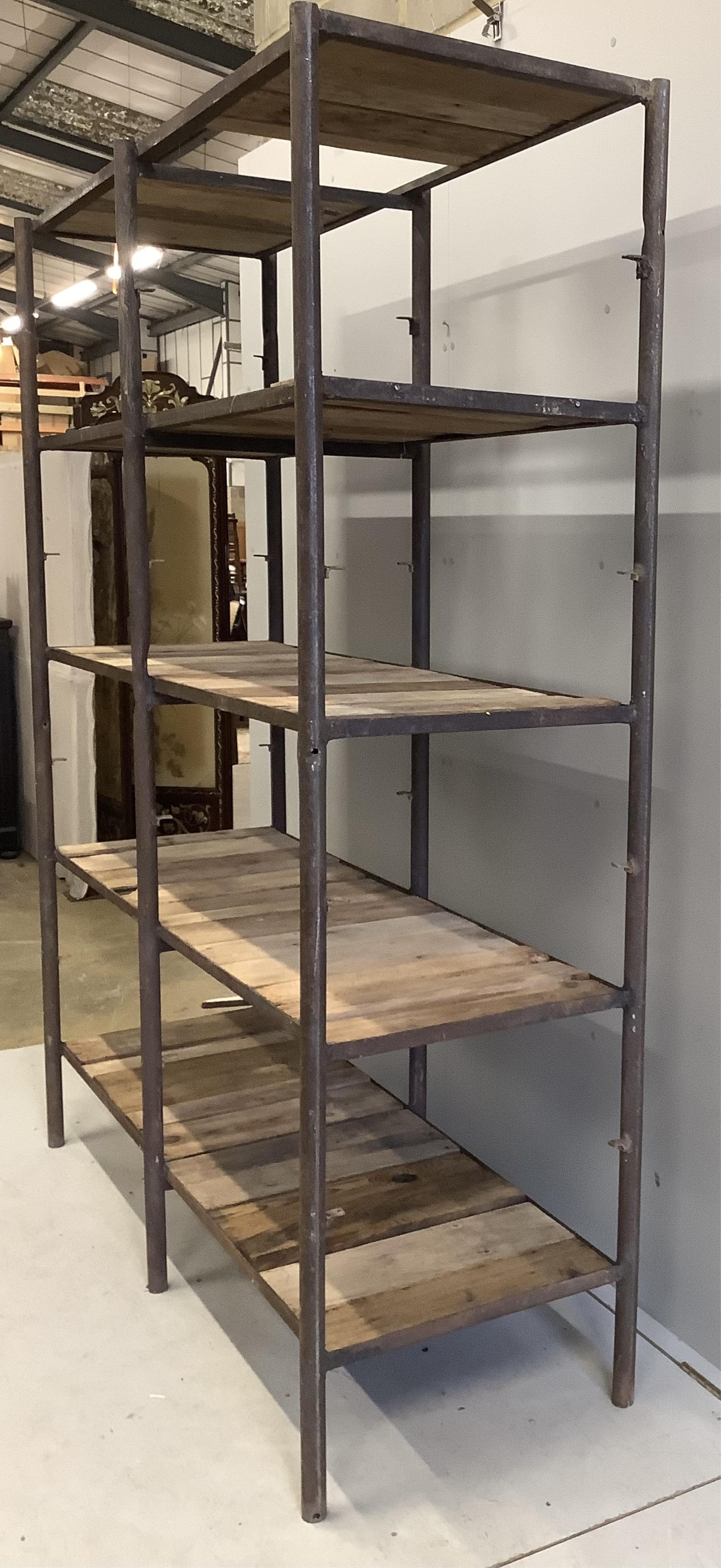 An industrial style wrought iron open shelf unit, width 154cm, depth 57cm, height 200cm. Condition - fair